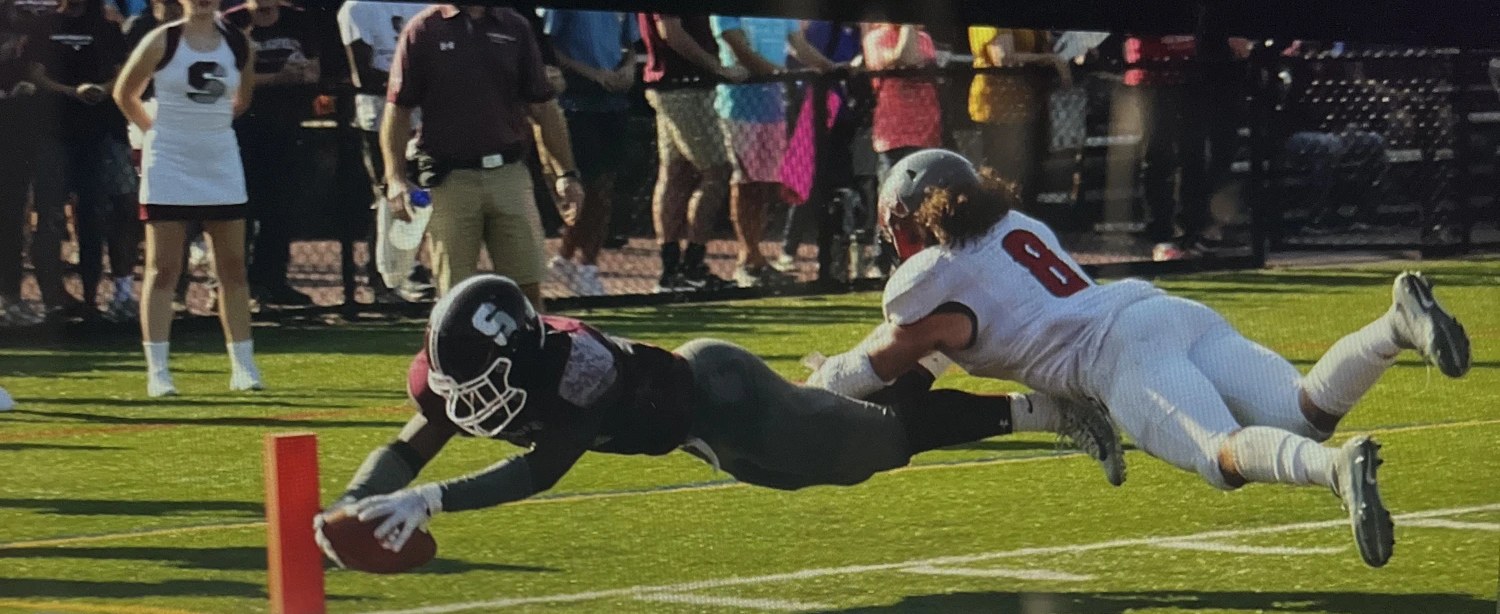 Kejuan Farquharson diving across the goal line to finish a 100-yard kickoff return touchdown for Springfield College